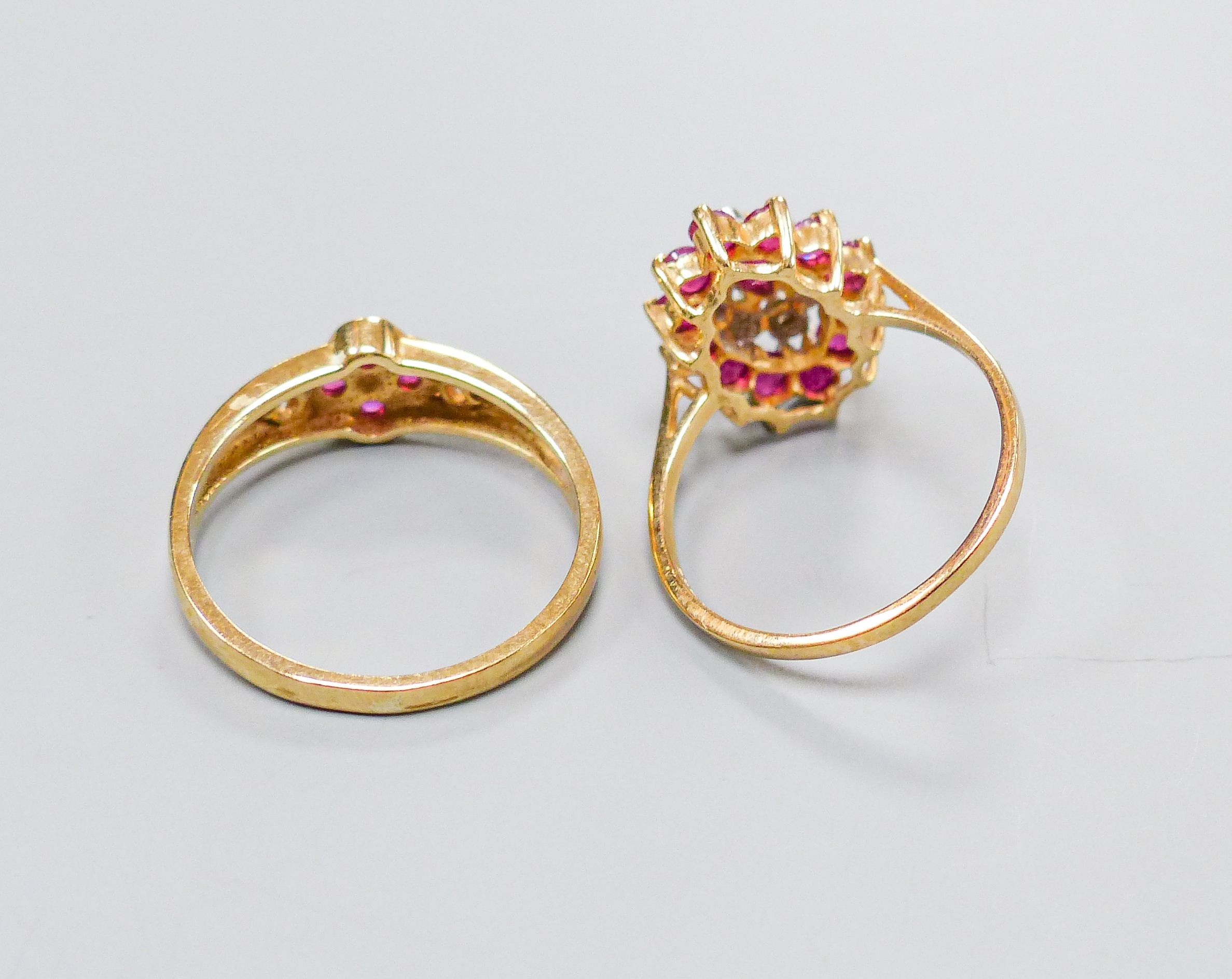 A 9ct yellow gold, ruby and diamond oval cluster ring, size M and another similar 9ct ring, gross 4.5 grams.